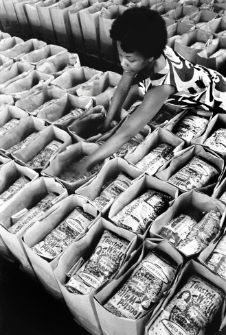 Earlene Coleman prepares bags of food for the Panther Free Food Program circa 1972 in Oakland. 