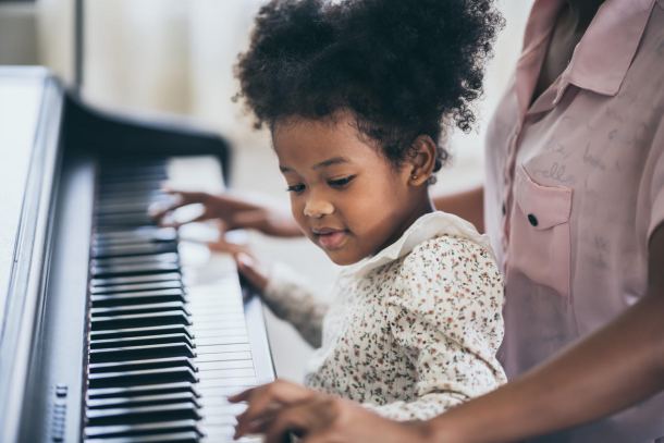 stock photo of child playing piano 