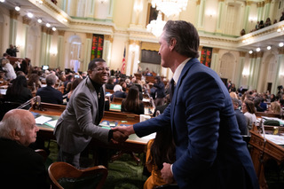 Assemblyman Corey Jackson (Riverside), left, shakes the hand of Gov. Gavin Newsom